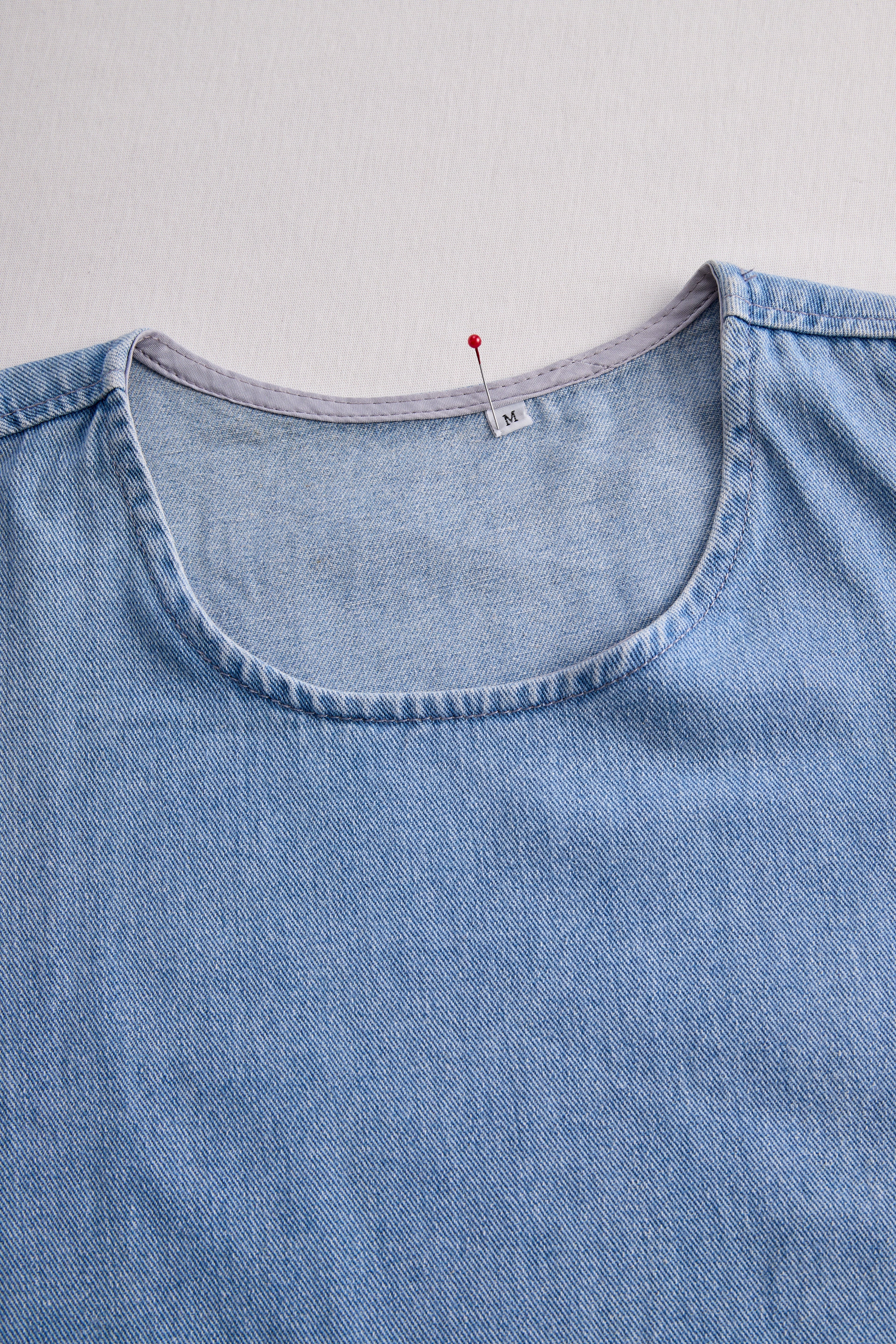 Stylish Denim Two-Piece Set With Asymmetrical Top And Fringed Skirt